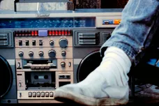 Close up of a male leg next to a large boom box