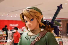 Link figurine from Legend of Zelda with shop staff inside