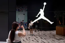 A woman takes a photo of the American sportwear brand,