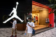 A pedestrian walks past the American sportwear brand and