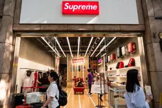 Pedestrians walk past an American skateboarding shop and