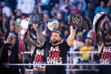 WORCESTER - Roman Reigns and The Usos raise their respective championship titles in the ring during "WWE Friday Night