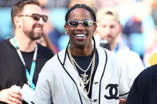 Feb 8, 2026; Santa Clara, CA, USA; Recording artist Travis Scott looks on from the sidelines before Super Bowl LX between the