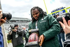 Music artist Tee Grizzley signs a football for a fan during the Michigan State spring game on Saturday, April 16, 2022, at
