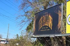 A billboard on Robeson Street near downtown Fayetteville, NC advertises the new album by rapper J. Cole, who was raised in the