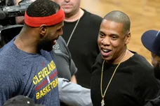 Dec 8, 2014; Brooklyn, NY, USA; Cleveland Cavaliers forward LeBron James (left) talks with Jay Z (right) during the game against