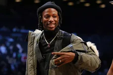 Feb 12, 2018; Brooklyn, NY, USA; American rapper Joey Bada$$ looks on from courtside during the fourth quarter between the