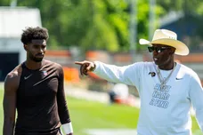Deion Sanders spends time with his son, Cleveland Browns quarterback Shedeur Sanders (2) at the conclusion of the second day of