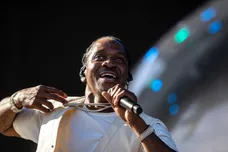 Pusha T holds out some of his jewelry to the crowd as he performs on the Coachella stage during the Coachella Valley Music and