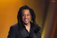 Jay-Z , left, accepts the Dr. Dre Global Impact Award with his daughter Blue Ivy on stage.