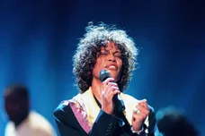 Whitney Houston rehearses with members of the choir "God's Property" at the Nashville Arena April 22, 1998 in preparation for