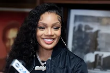 Rapper GloRilla smiles during a press conference to present a check for $25,000 to Melrose High School, where she graduated from