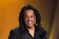 Jay-Z , left, accepts the Dr. Dre Global Impact Award with his daughter Blue Ivy on stage.