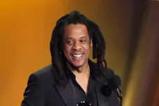 Jay-Z , left, accepts the Dr. Dre Global Impact Award with his daughter Blue Ivy on stage.