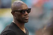 Former NFL wide receiver Terrell Owens stands on the Jackson State University sideline during the Orange Blossom Classic between