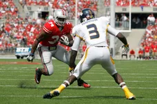 Carlos Hyde #34 of the Ohio State Buckeyes attempts to run past Desmond Marrow #3 of the Toledo Rockets on September 10, 2011 at Ohio Stadium in Columbus, Ohio.