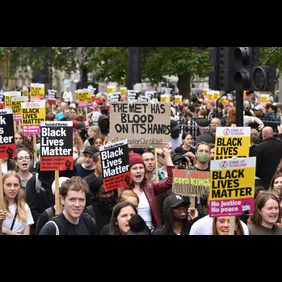 Protesters hold placards expressing their opinion during the