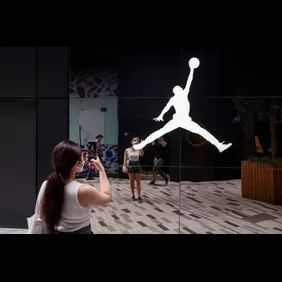 A woman takes a photo of the American sportwear brand,