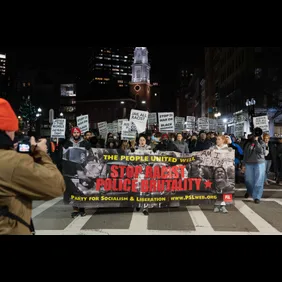 Protesters hold placards and a banner in Downtown Boston