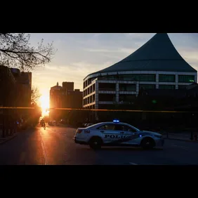 Police cars and cordon tape block Main Street near the Old