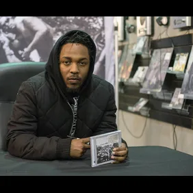 Kendrick Lamar Signs Copies Of His New Album "To Pimp A Butterfly"