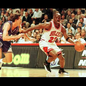 Chicago Bulls player Michael Jordan sticks out his