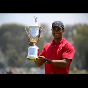 Tiger Woods of the US holds his trophy a