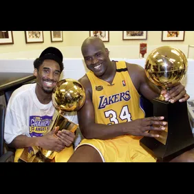 Kobe Bryant (L) of the Los Angeles Lakers holds th