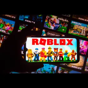 In this photo illustration the Roblox logo seen displayed on