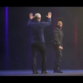 Apple CEO Tim Cook (left) wraps up the keynote with a live performance from The Weeknd (right), with a world premiere of his next song at Moscone West in San Francisco, California, on Monday, June 8, 2015.