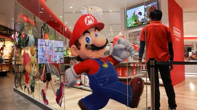 An employee stands next to a Super Mario decoration sticker