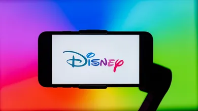 In this photo illustration, Disney logo is seen displayed on