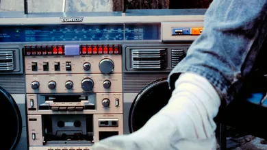 Close up of a male leg next to a large boom box