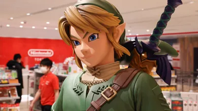 Link figurine from Legend of Zelda with shop staff inside