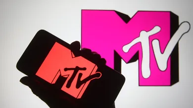 In this photo illustration a silhouette hand is seen holding