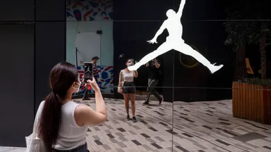 A woman takes a photo of the American sportwear brand,
