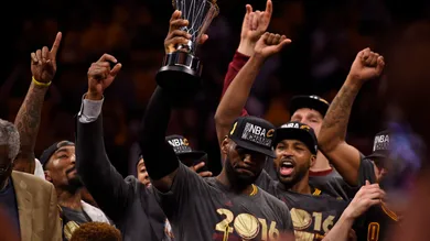 With tears in his eyes Cleveland Cavaliers' LeBron James (23) holds up the MVP trophy after defeating the Golden State Warriors in Game 7 of the NBA Finals at Oracle Arena in Oakland, Calif., on Sunday, June 19, 2016. The Cleveland Cavaliers defeated the