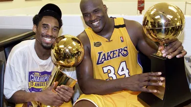 Kobe Bryant (L) of the Los Angeles Lakers holds th