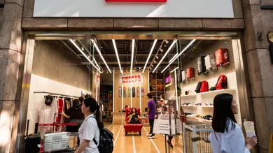 Pedestrians walk past an American skateboarding shop and