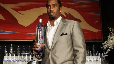 Sean "Diddy" Combs holds a bottle of Cir