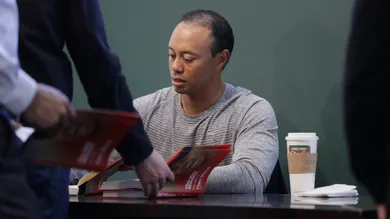 Tiger Woods Signs Copies Of His New Book "The 1997 Masters: My Story"