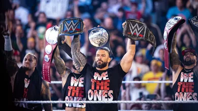 WORCESTER - Roman Reigns and The Usos raise their respective championship titles in the ring during "WWE Friday Night