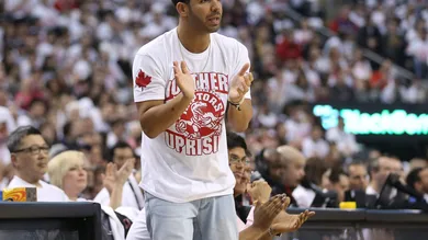 Apr 19, 2014; Toronto, Ontario, CAN; Actor and rap artist Drake cheers on his team during the Toronto Raptors game against the