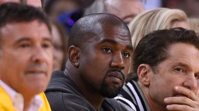 May 27, 2015; Oakland, CA, USA; Entertainer and rapper Kanye West (middle) during the first half against the Houston Rockets in