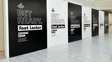A construction barrier at Freehold Raceway Mall highlights a new Foot Locker store on the way.
