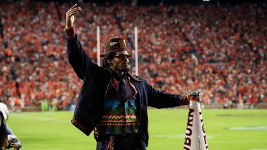 Former Auburn quarterback Cam Newton cheers on his team from the sideline as Auburn Tigers take on Georgia Bulldogs at