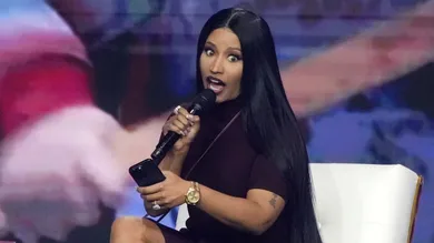 Nicki Minaj takes the stage with Erika Kirk at the Phoenix Convention Center during the final day of AmericaFest on Dec. 21,