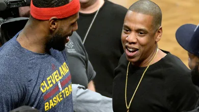 Dec 8, 2014; Brooklyn, NY, USA; Cleveland Cavaliers forward LeBron James (left) talks with Jay Z (right) during the game against