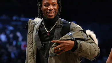Feb 12, 2018; Brooklyn, NY, USA; American rapper Joey Bada$$ looks on from courtside during the fourth quarter between the