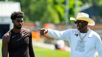 Deion Sanders spends time with his son, Cleveland Browns quarterback Shedeur Sanders (2) at the conclusion of the second day of